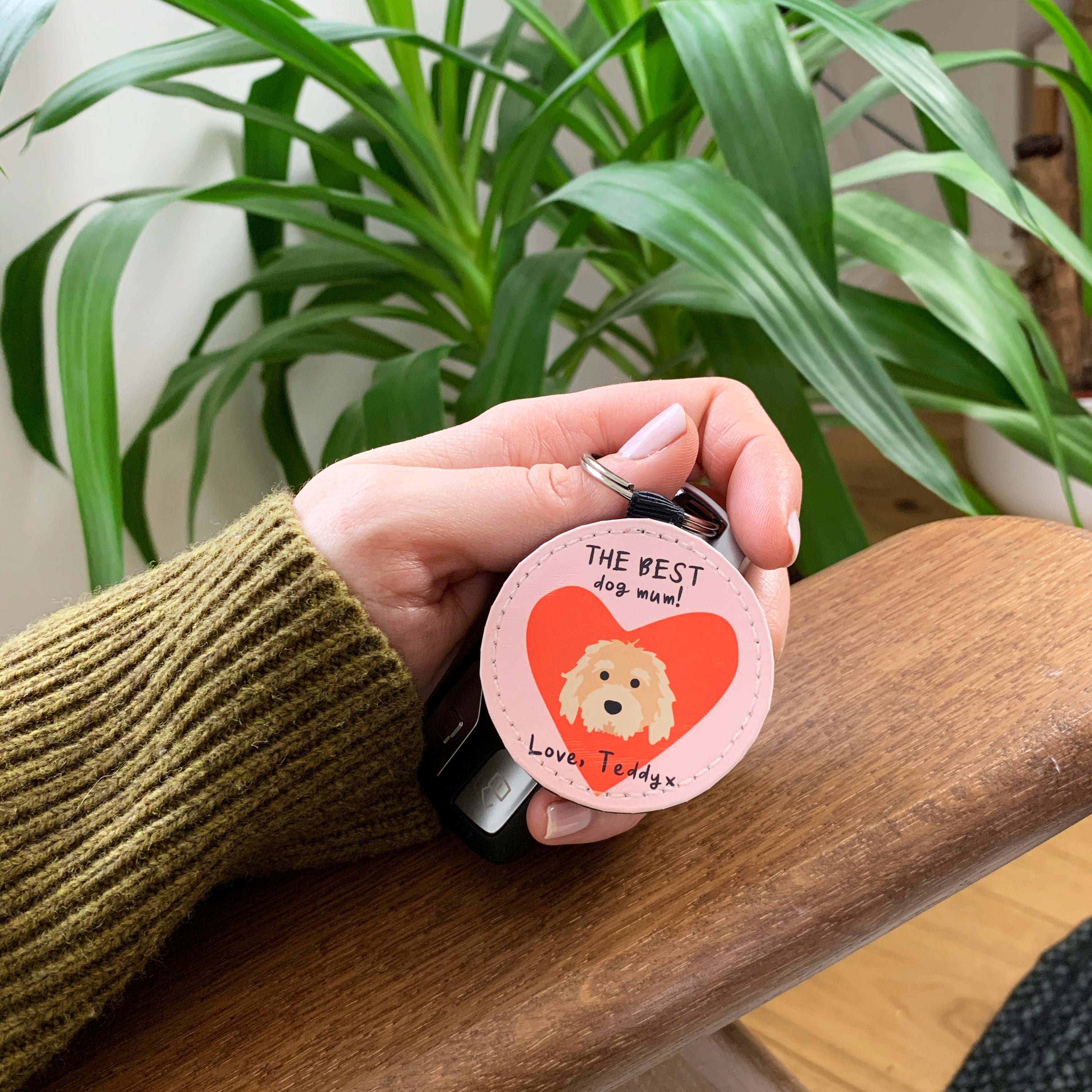 circular keyring, pink background with red heart and a picture of your chosen dog breed, text reads; the best dog [inser name i.e. mum] Love, [insert dogs name]